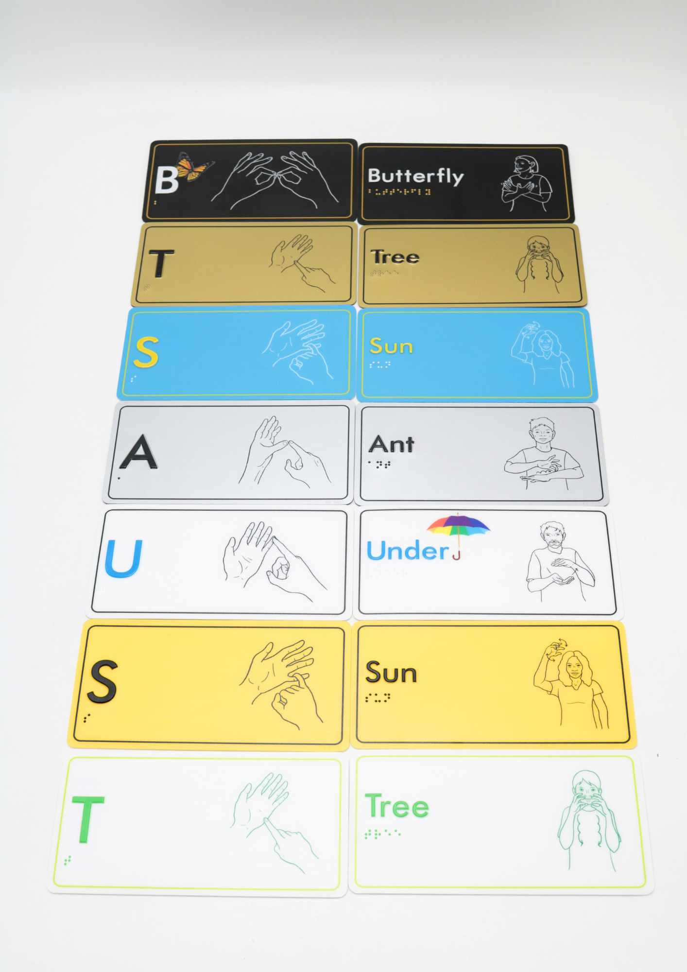 Educational braille signage with letters and AUSLAN hand illustrations.