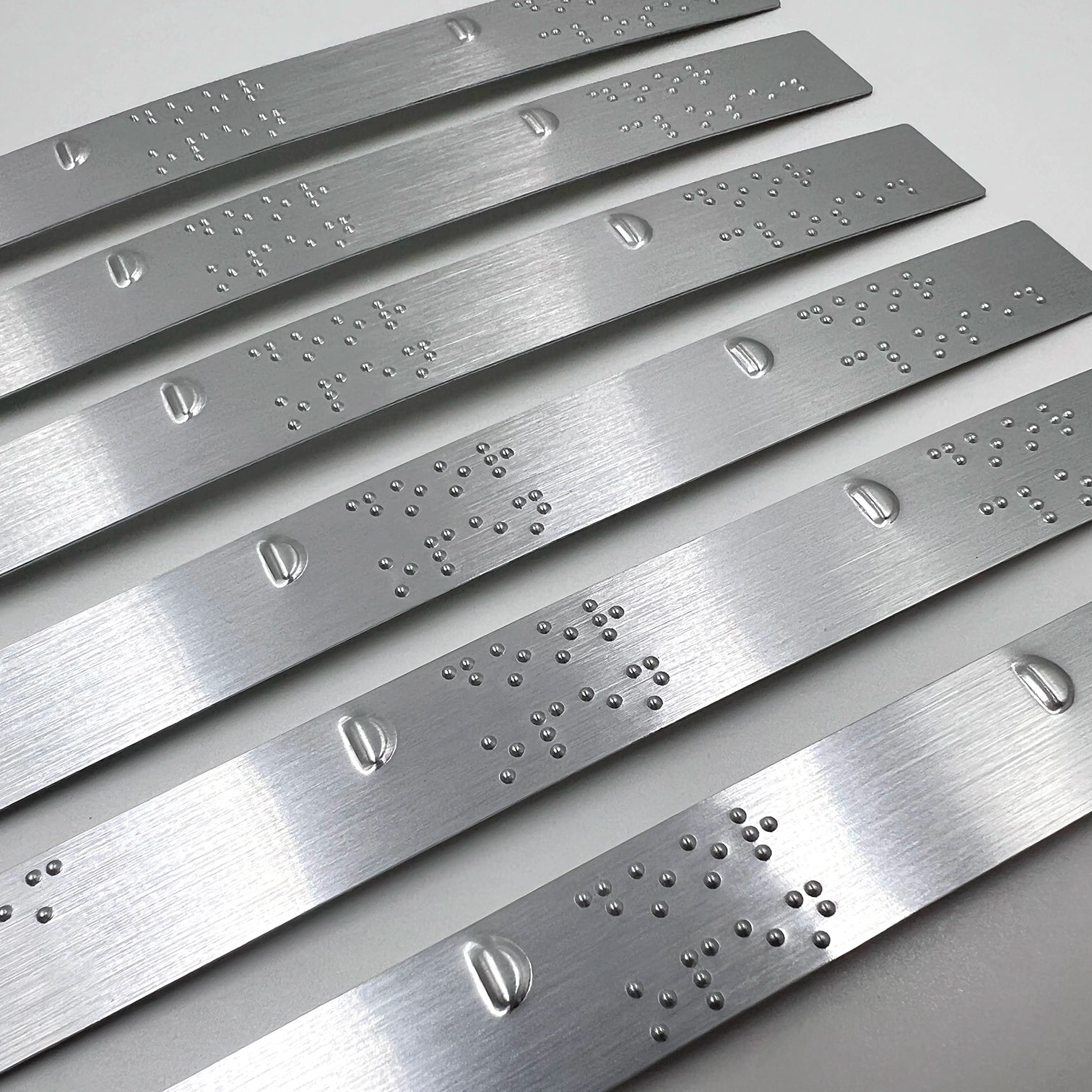 Set of silver braille strips.