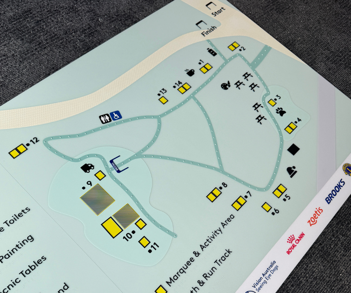 Braille tactile map of a park layout with various markers.