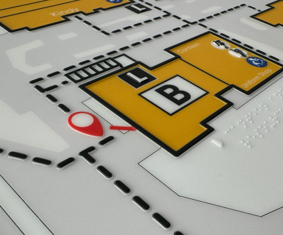 Close-up of a tactile map with Braille labels and color coding