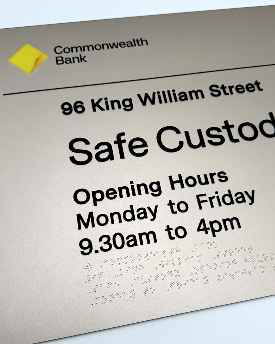 Commonwealth Bank safe custod sign with address and opening hours and braille elements.