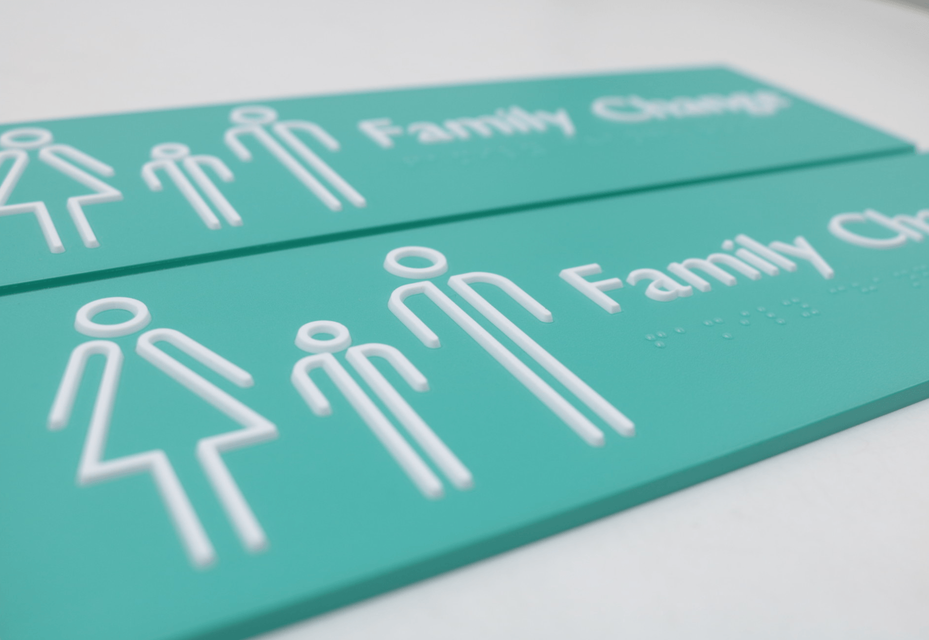 Teal blue braille signage sign for family change room.
