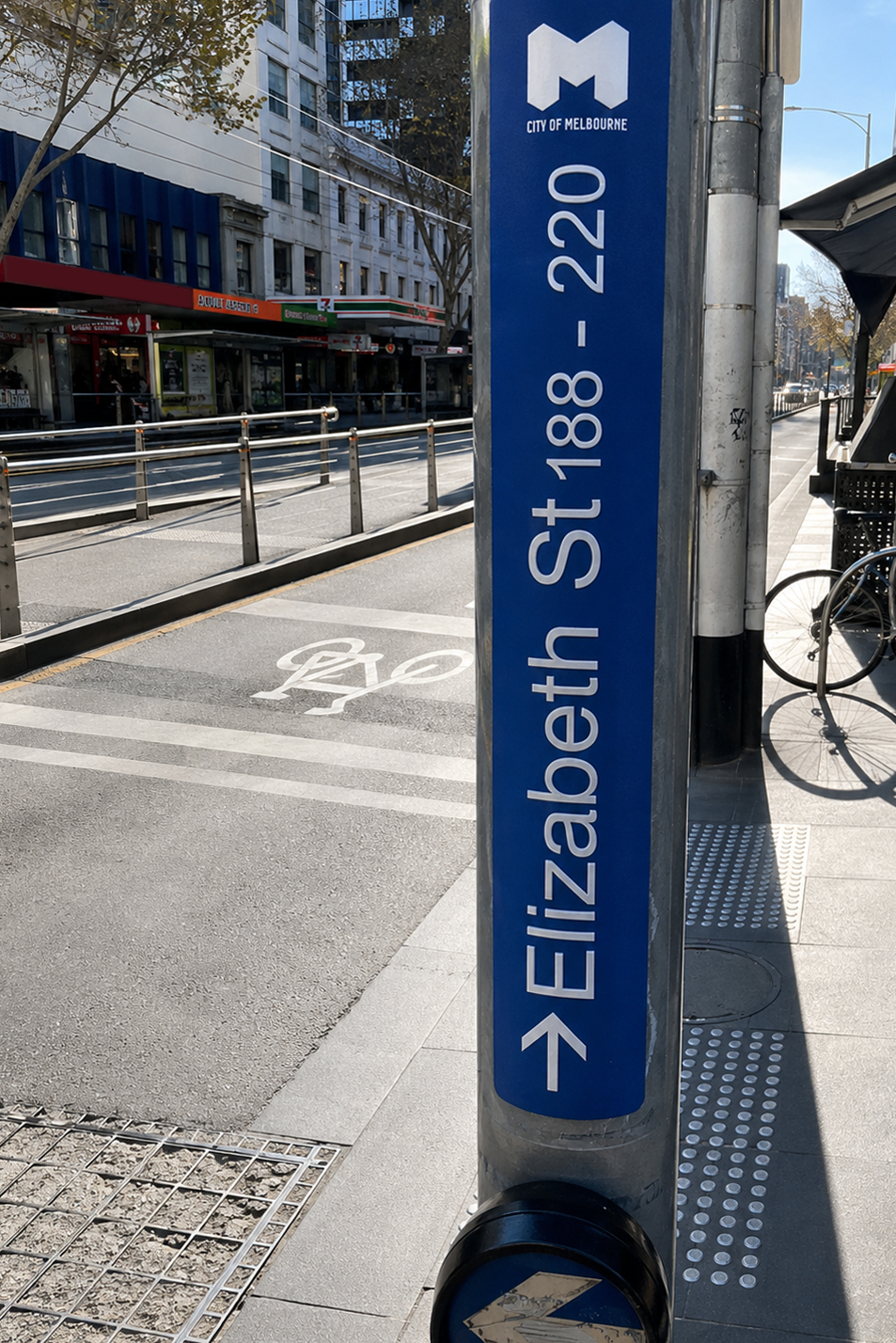 Blue street sign indicating Elizabeth St 188-220 on a city street.