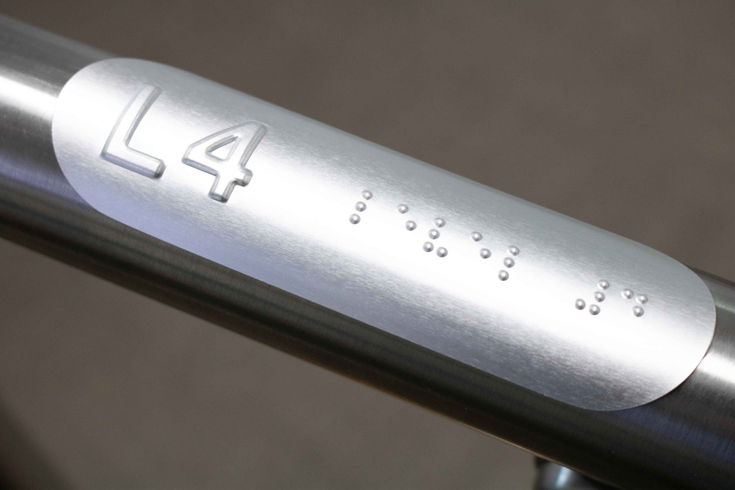 Handrail indicator with braille and tactile text.