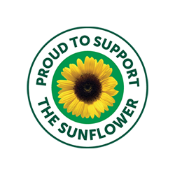 A circular green and white logo featuring a yellow sunflower in the center with the text 'PROUD TO SUPPORT THE SUNFLOWER' in green around it, shown on a plain white background.