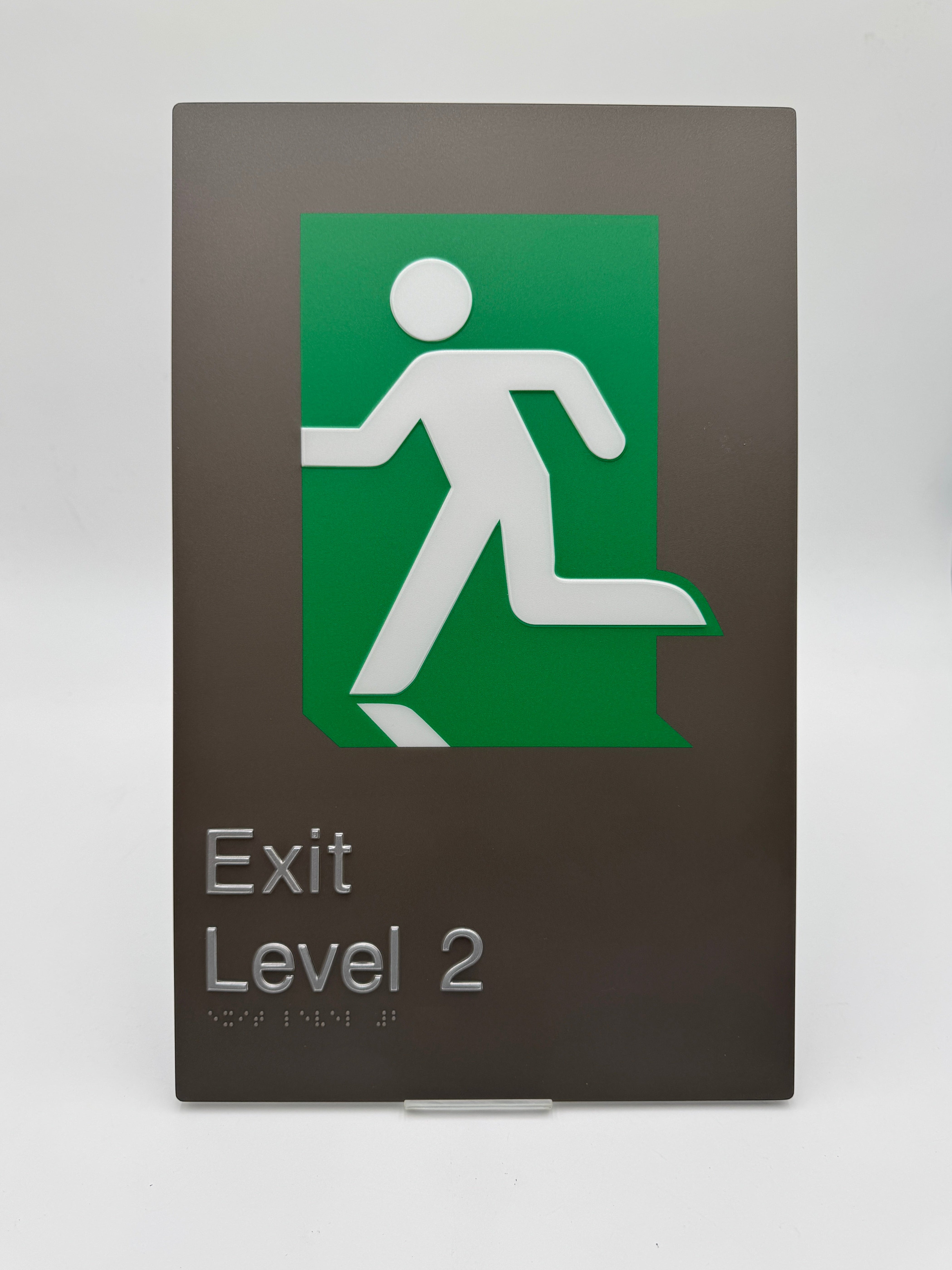 Exit level 2 braille sign with a green background and white figure on a brown background.