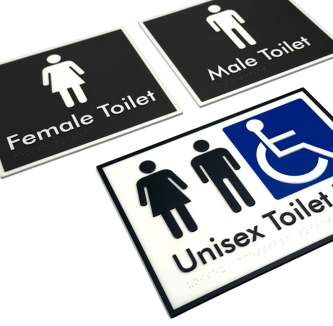 Set of bathroom braille signs indicating male, female, and unisex disabled toilets.