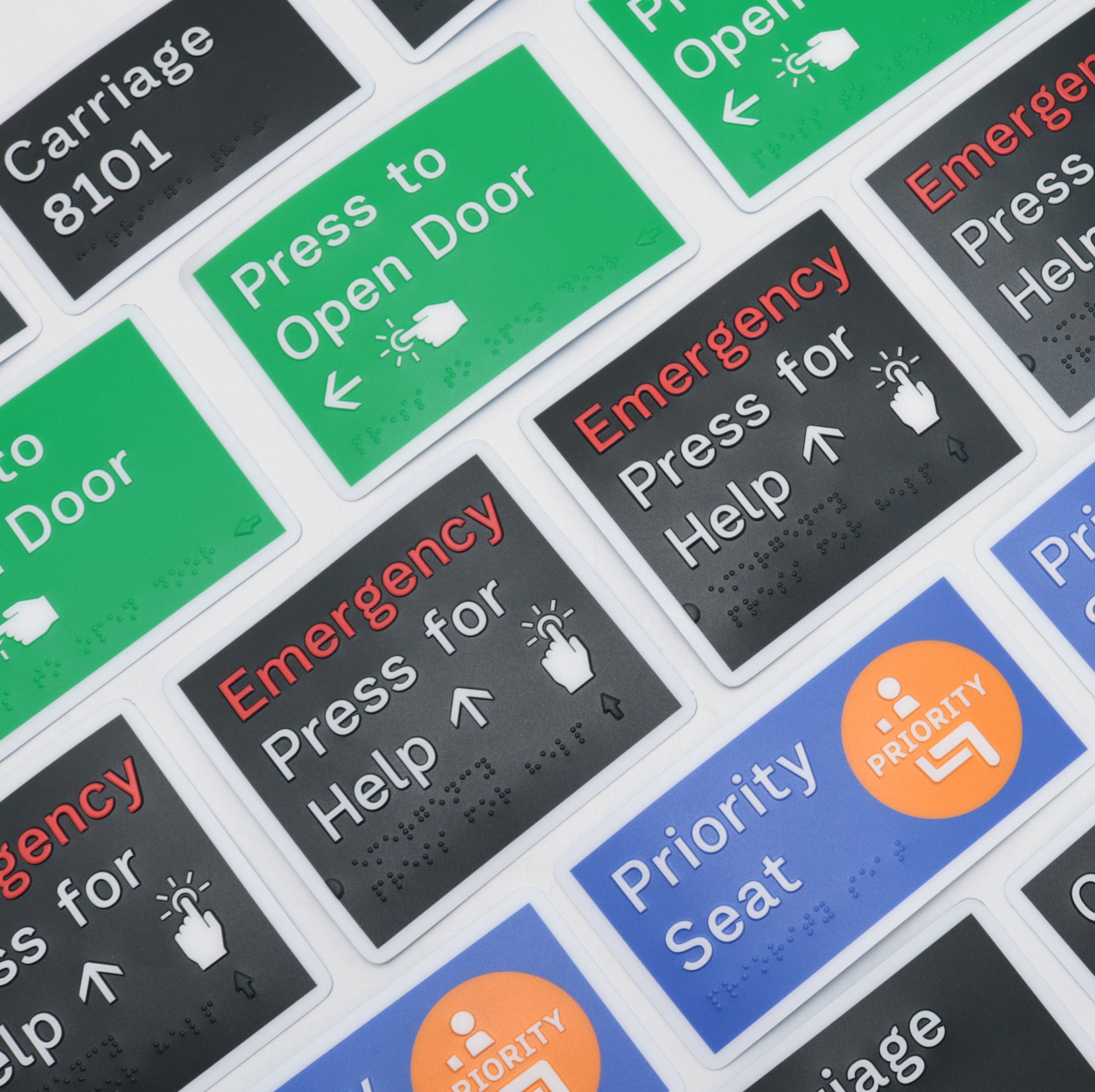 Various examples of braille signs for open door, emergency, priority seating.