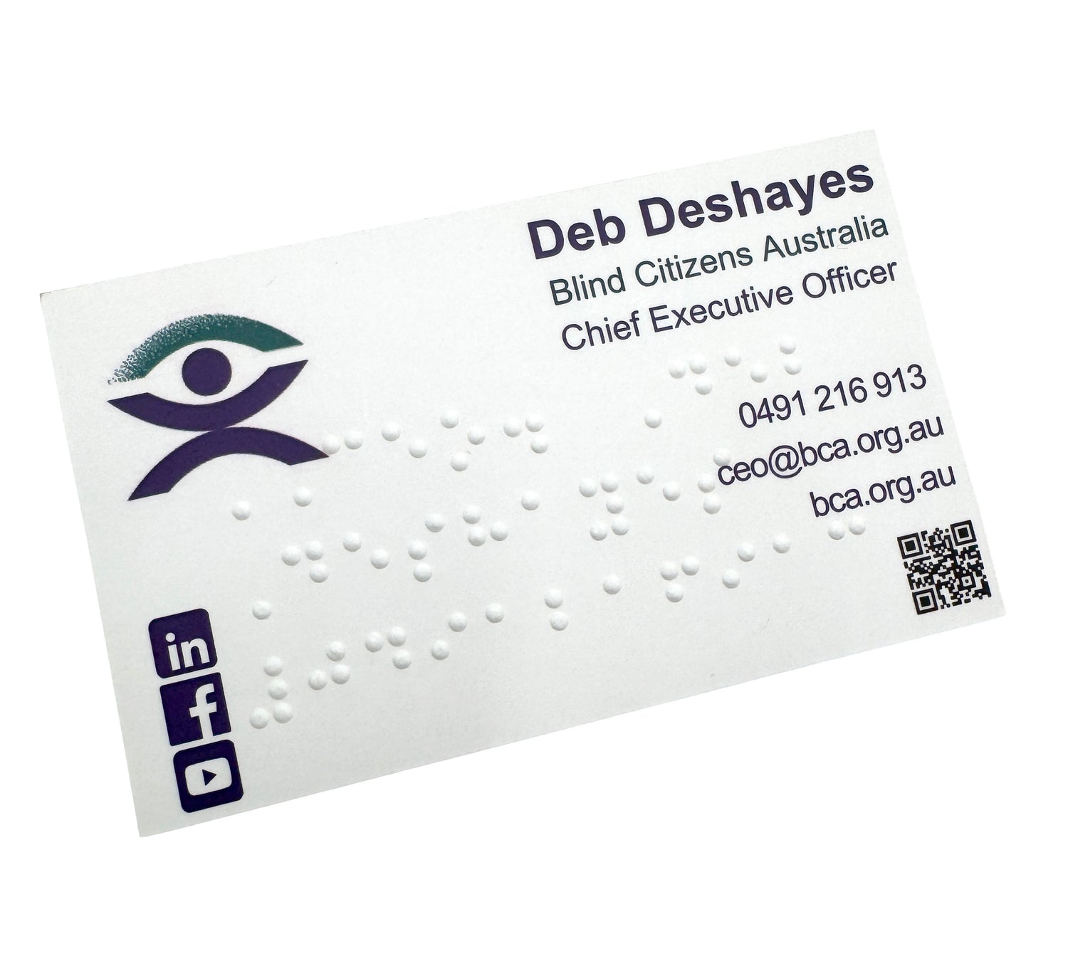 Business card with braille text, logo, and contact information on a white background.