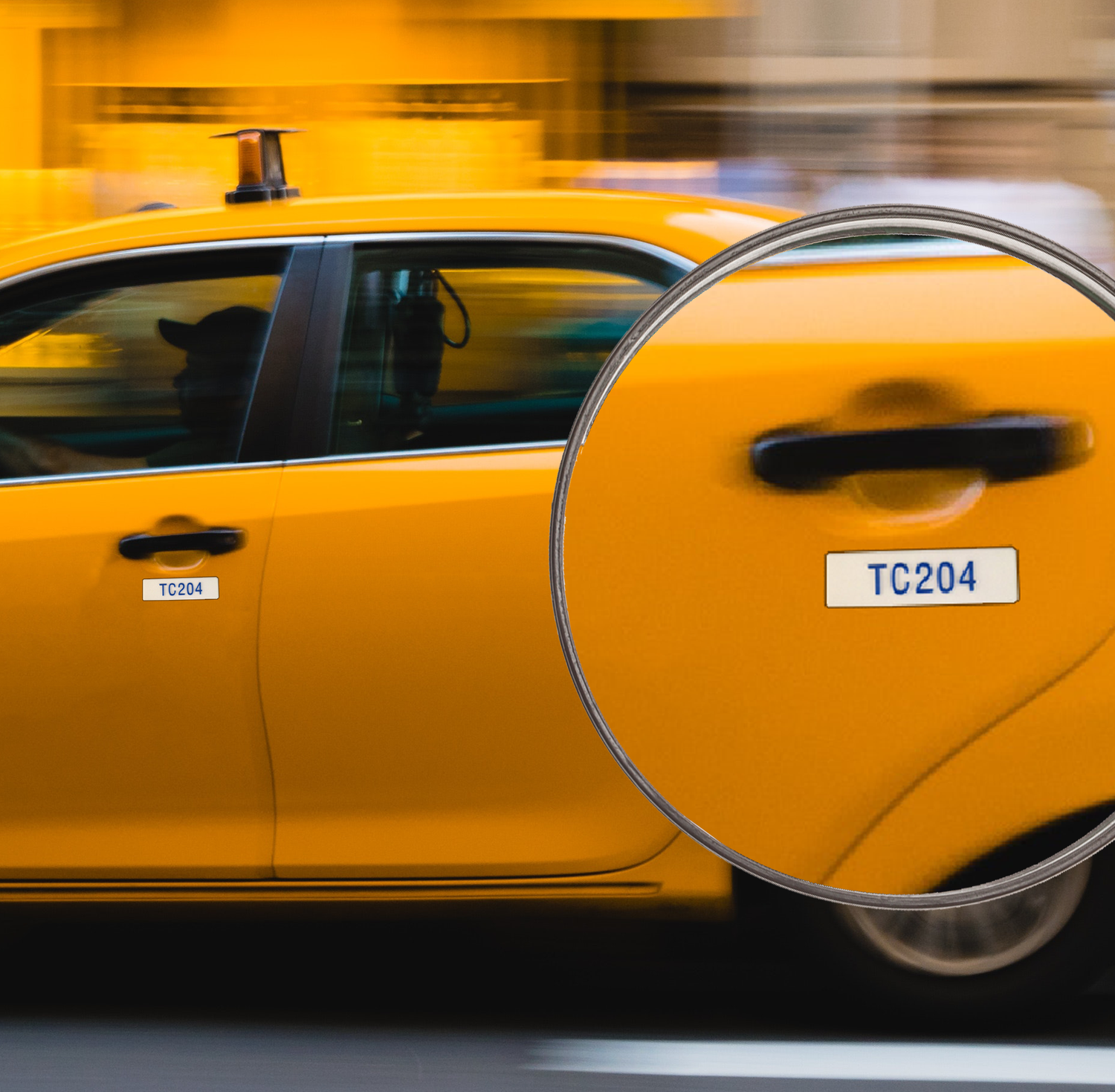 Yellow taxi with a close-up of a door handle with braille taxi label.